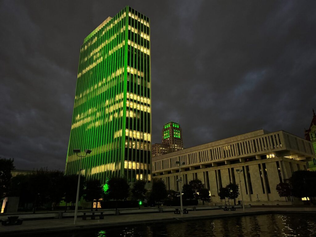 A tower at Empire State Plaza in Albany lit green, October 9, 2026