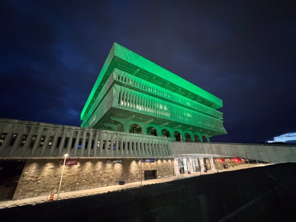 The New York State Museum building at Empire State Plaza in Albany lit green, October 9, 2026