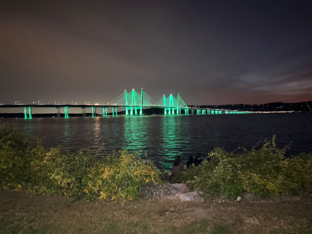The Governor Mario M. Cuomo Bridge lit green over the Hudson River