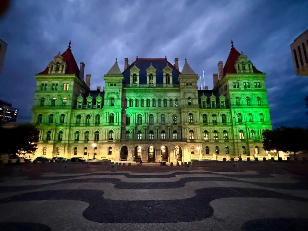 The New York State Capitol in Albany lit green